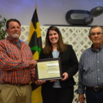 Acting NRCS State Conservationist Jackie Byam presents Donnie Bowen and Leslie (Page) Bowen with a citation